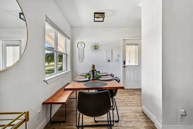 a dining room with furniture and window