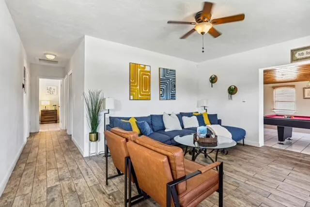 a living room with furniture and wooden floor