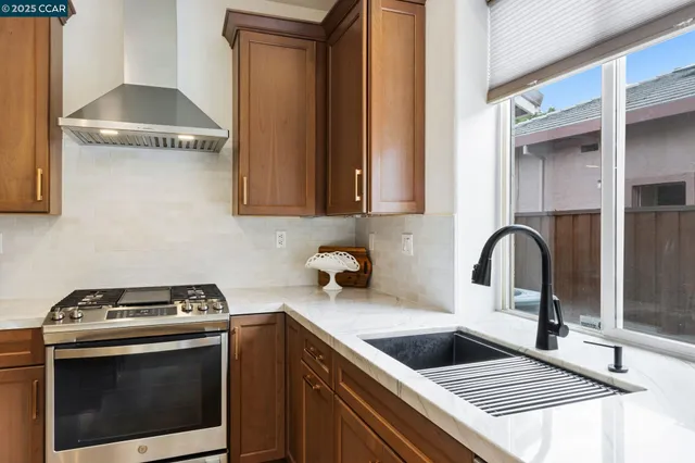 a kitchen with a sink stove and cabinets