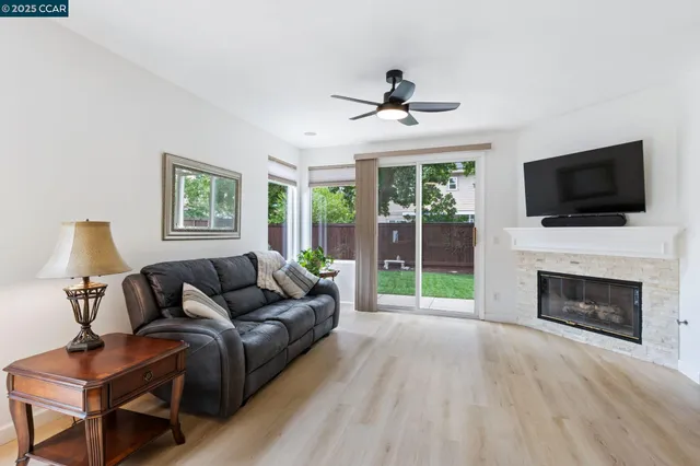 a living room with furniture a fireplace and a flat screen tv