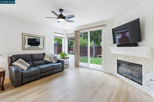 a living room with furniture a fireplace and a flat screen tv