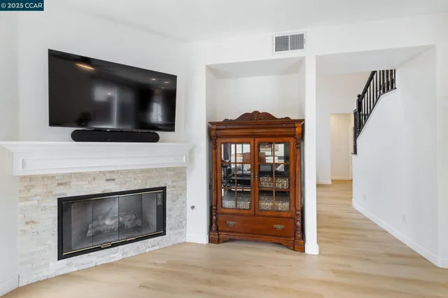 a living room with a fireplace and a flat screen tv