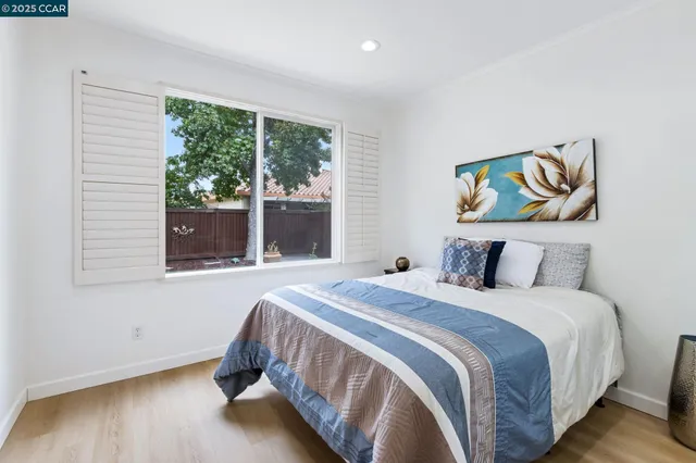 a bedroom with a bed and a large window