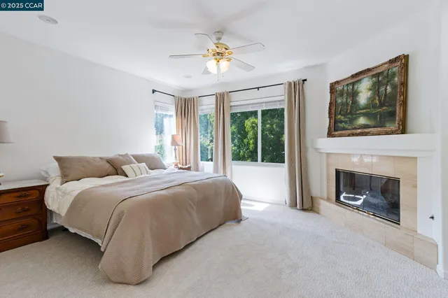 a spacious bedroom with a bed and a fireplace