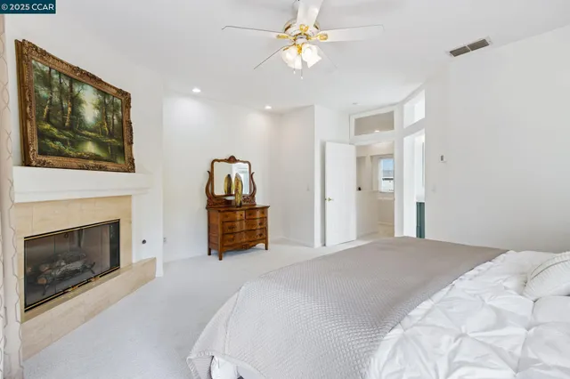 a spacious bedroom with a bed and a fireplace