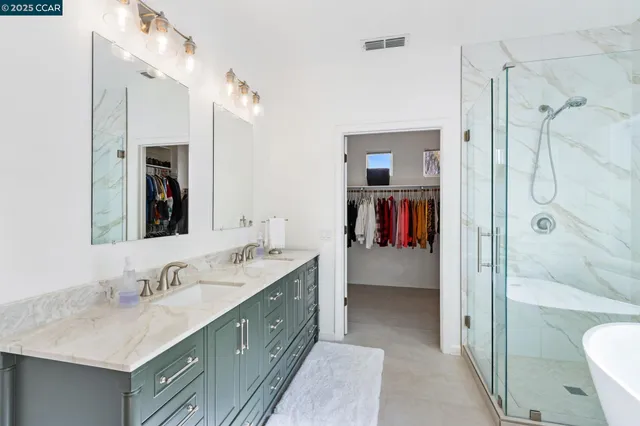 a bathroom with a tub sink mirror and shower