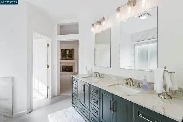 a spacious bathroom with a double vanity sink a and a mirror