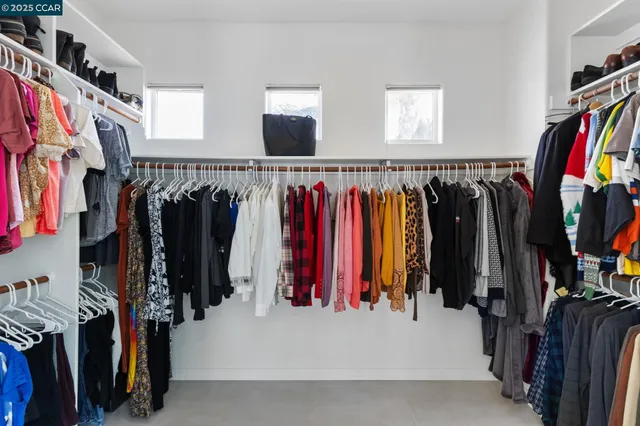 a view of walk in closet with clothes