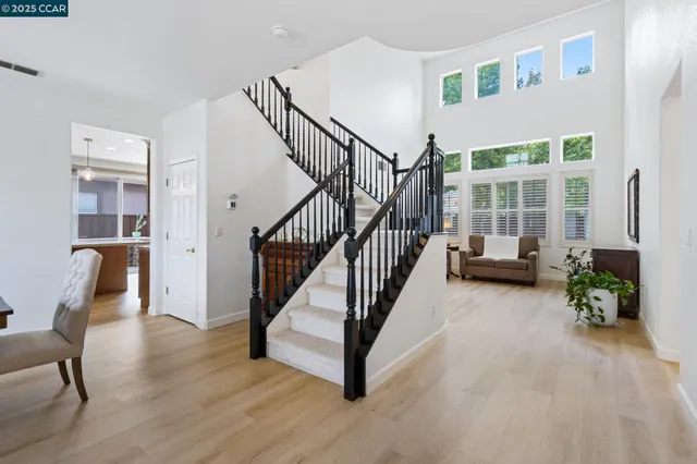 a view of a livingroom with furniture and stairs