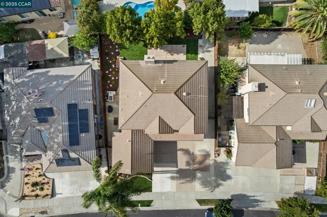 an aerial view of residential houses with outdoor space and parking