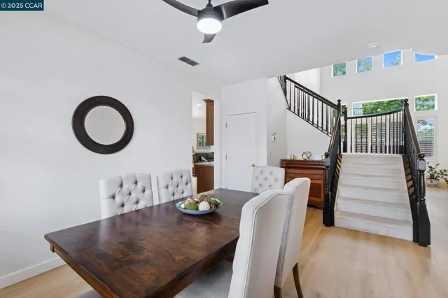 a view of a dining room with furniture and a potted plant
