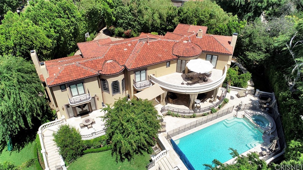 an aerial view of residential house with outdoor space and swimming pool
