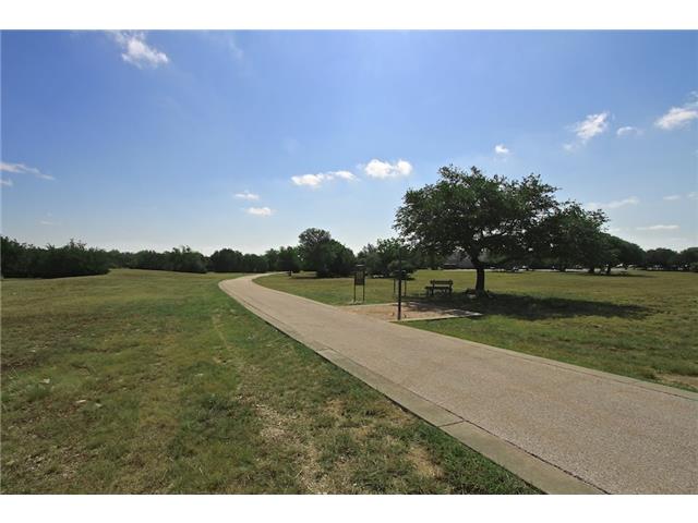 7006 Rambollet Terrace Round Rock, TX 78681 - Photo 36 of 38 A winding pathway invites leisurely strolls through this tranquil green space, shaded by mature trees.