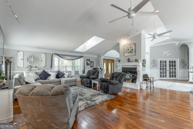 a bathroom with a granite countertop toilet a sink and a mirror
