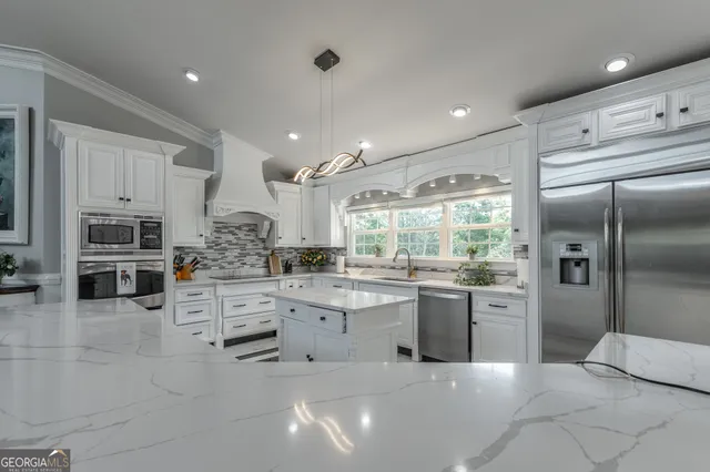 a living room with furniture wooden floor and a chandelier