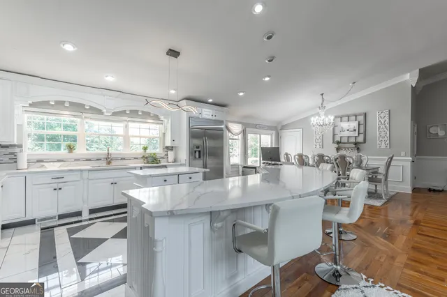 a kitchen with stainless steel appliances granite countertop a sink a stove and cabinets
