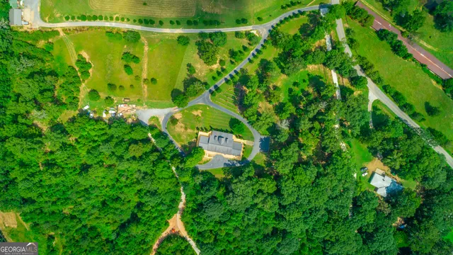 a living room with furniture fireplace and a large window