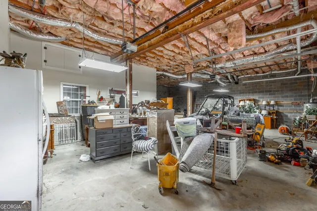 an aerial view of a house with a yard and trees all around