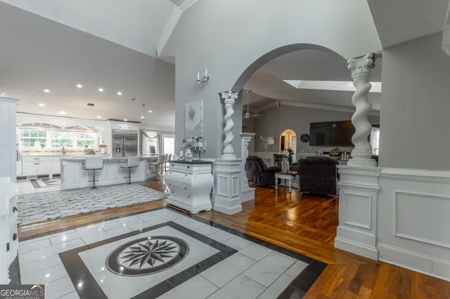 a large living room with a fireplace and wooden floor