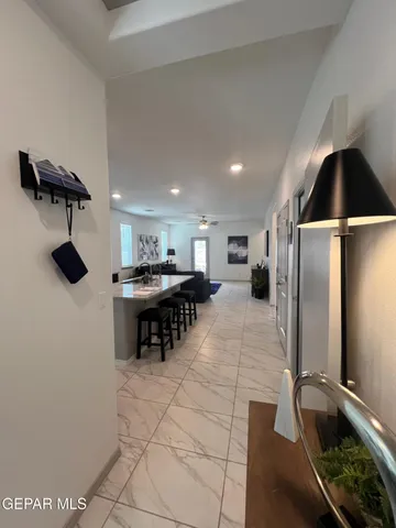 a kitchen with stainless steel appliances kitchen island granite countertop a refrigerator and a sink