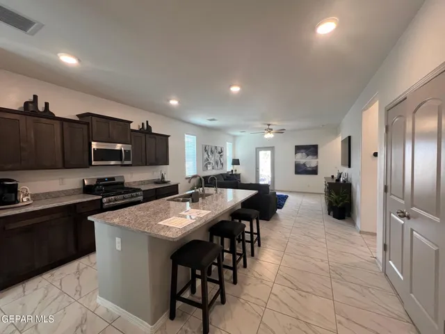 a large kitchen with stainless steel appliances lots of counter space and breakfast area