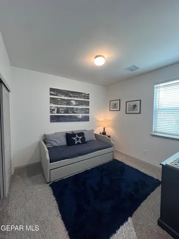 a living room with a couch and a window