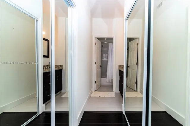 a view of walk in closet with living room