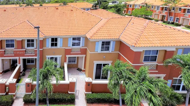 a front view of a residential houses with yard and car parked