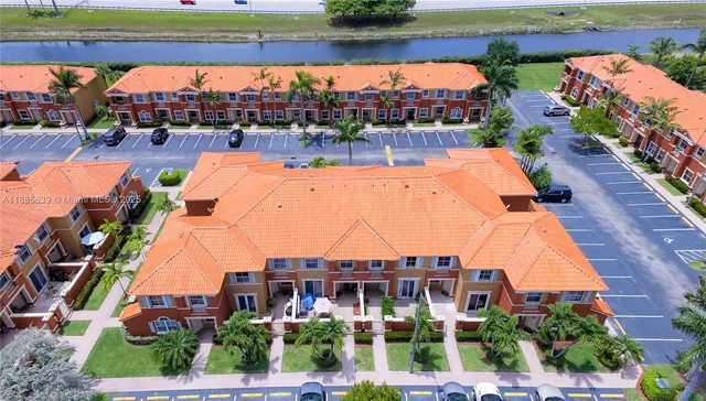 an aerial view of swimming pool outdoor seating and yard