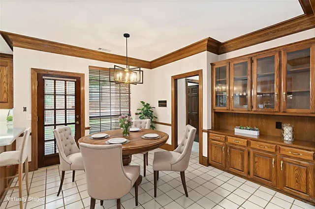 a dining room with furniture a chandelier and window