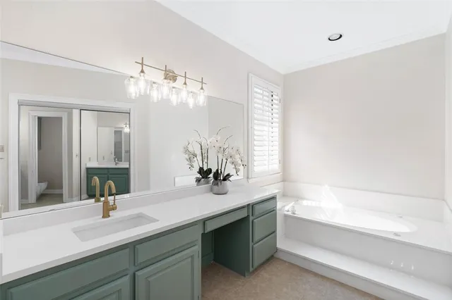a bathroom with a tub sink and mirror