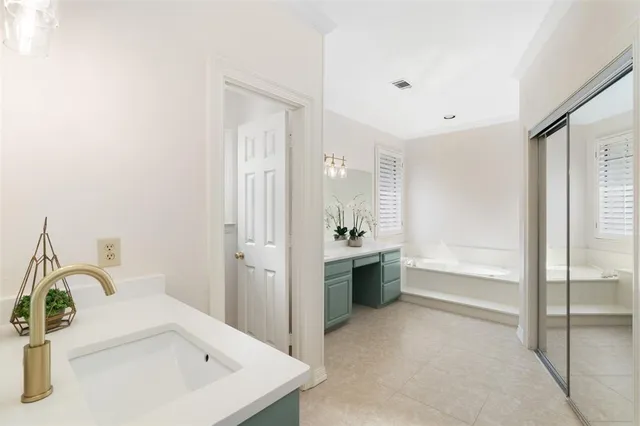 a bathroom with a bathtub and a sink