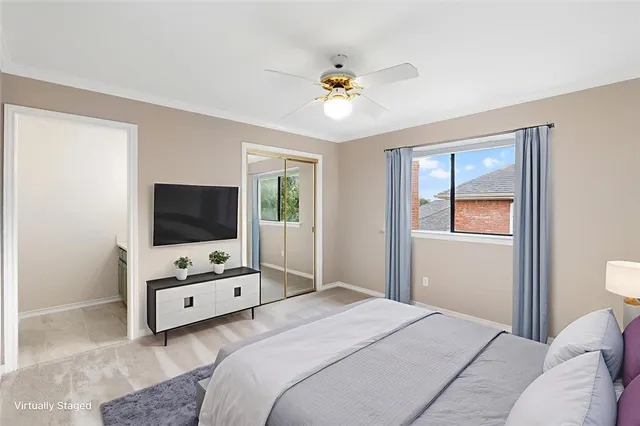 a bedroom with a bed and a flat tv screen on dresser