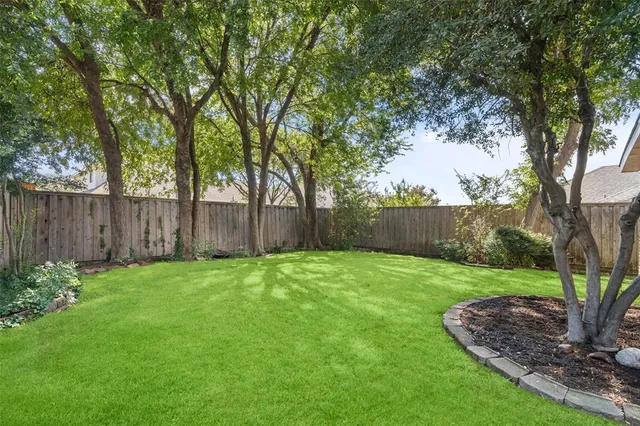 a view of a backyard with large trees