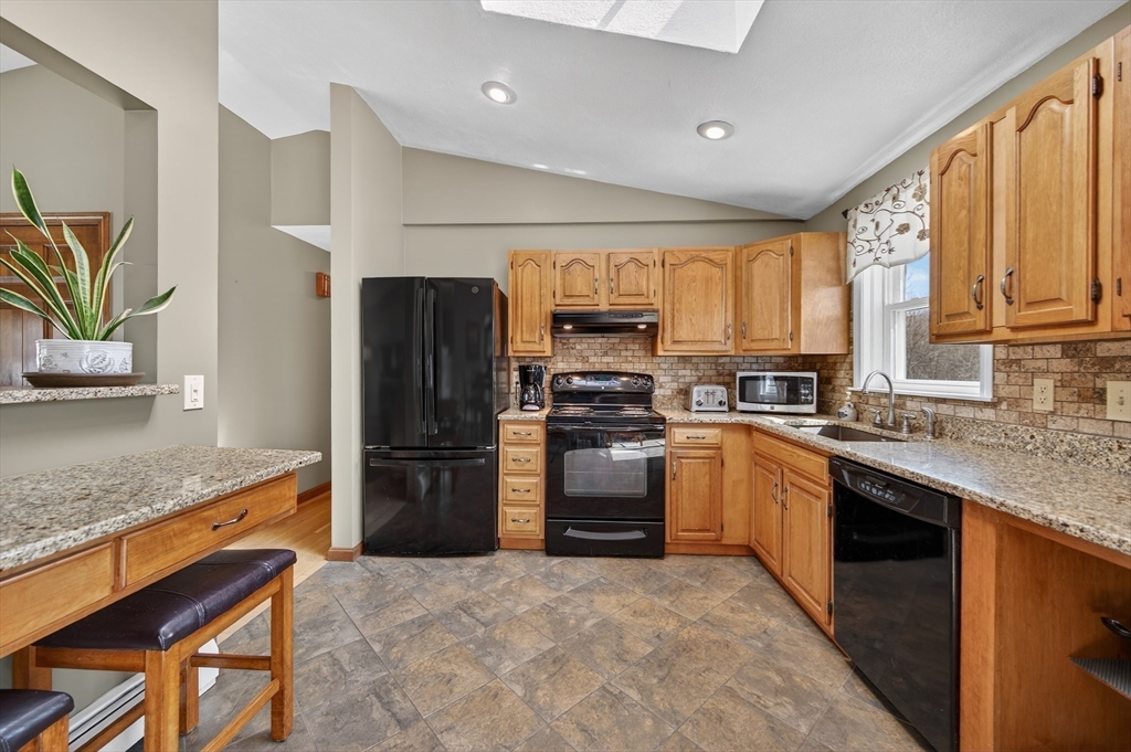 1079 Langley Street Fall River, MA 02720 - Photo 12 of 40 a kitchen with a refrigerator and a sink
