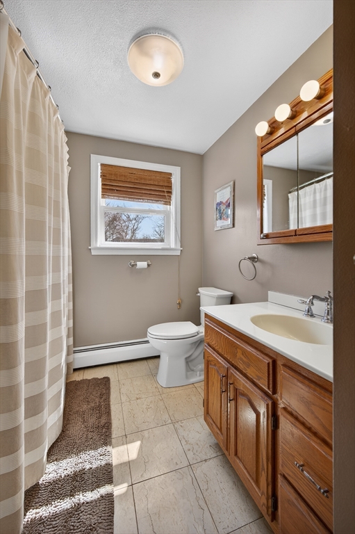 1079 Langley Street Fall River, MA 02720 - Photo 15 of 40 a spacious bathroom with a granite countertop sink a toilet and a mirror