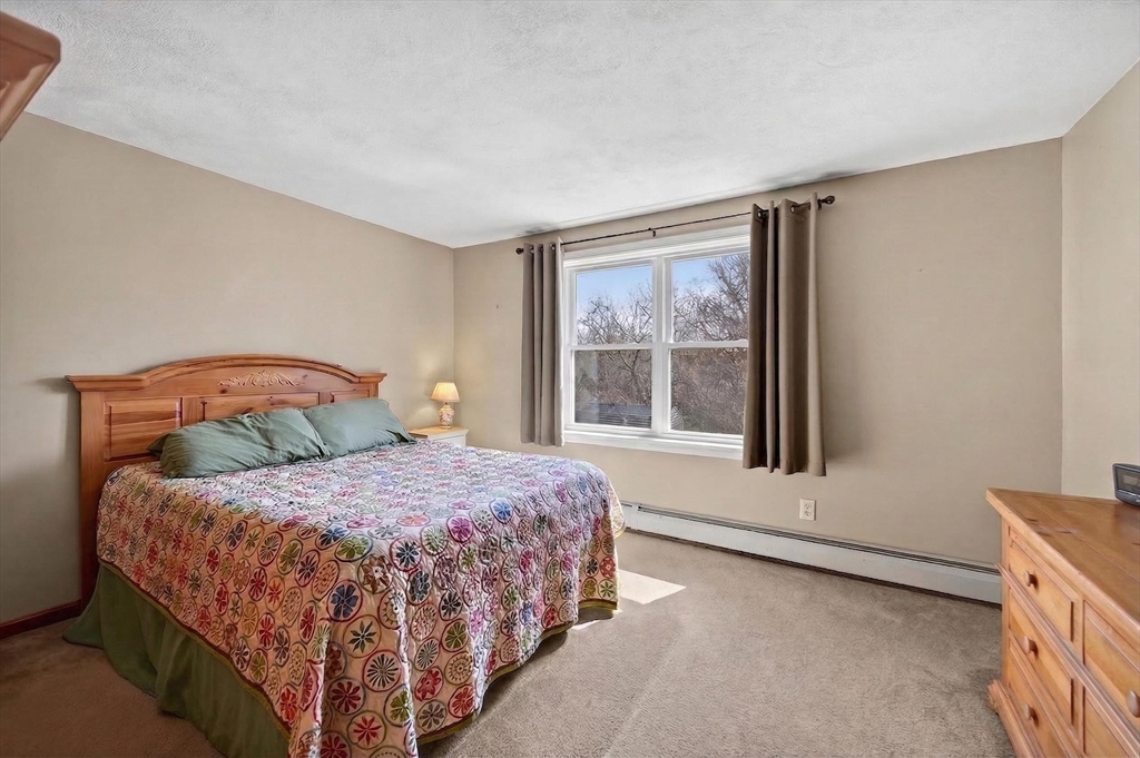 1079 Langley Street Fall River, MA 02720 - Photo 16 of 40 a bedroom with a bed and a window