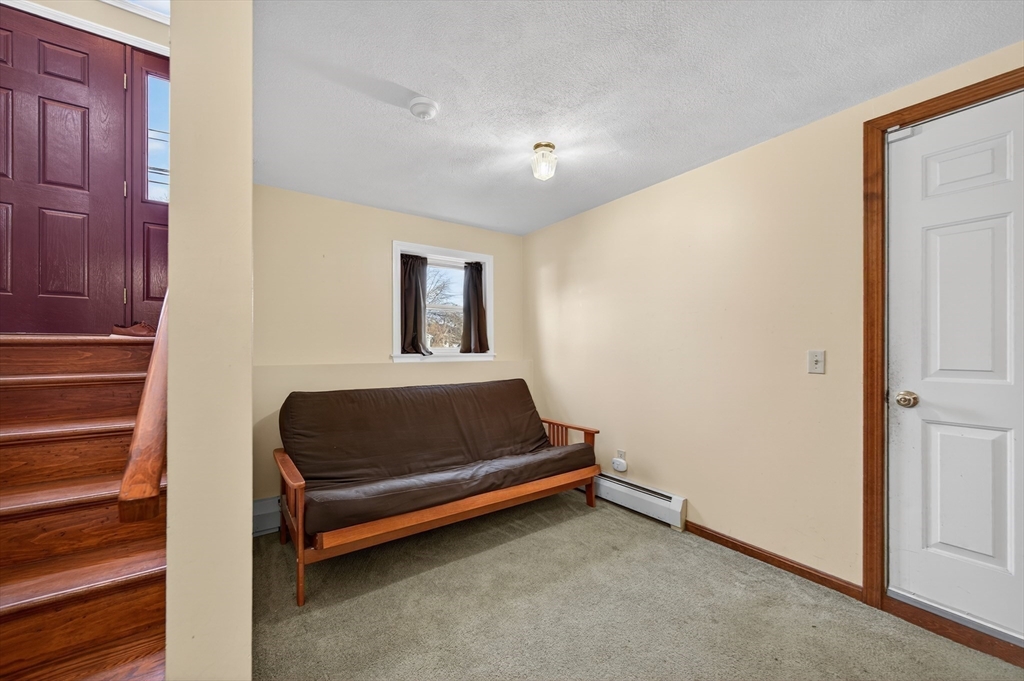 1079 Langley Street Fall River, MA 02720 - Photo 21 of 40 a blue bed sitting in a room next to a window