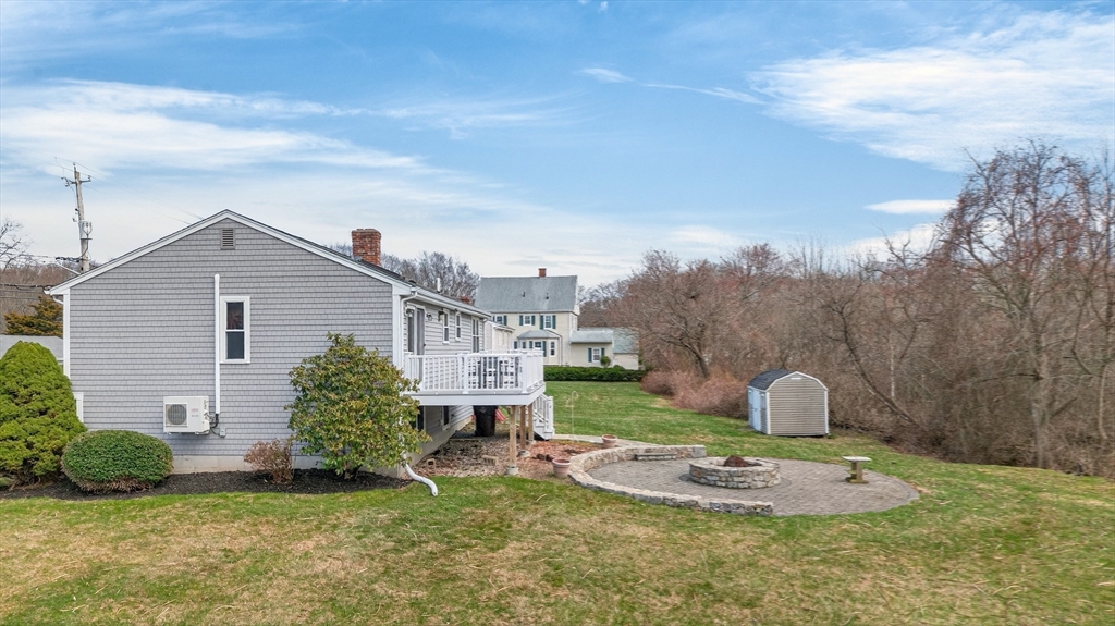 1079 Langley Street Fall River, MA 02720 - Photo 34 of 40 a front view of a house with a garden and plants