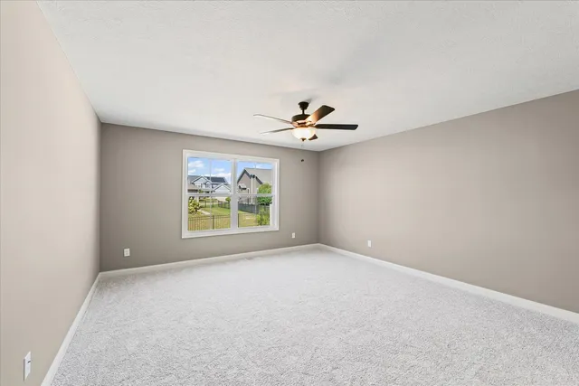 a view of room with window and ceiling fan