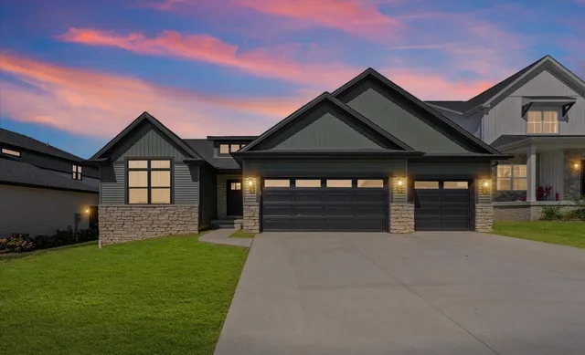 a front view of a house with a garden and yard
