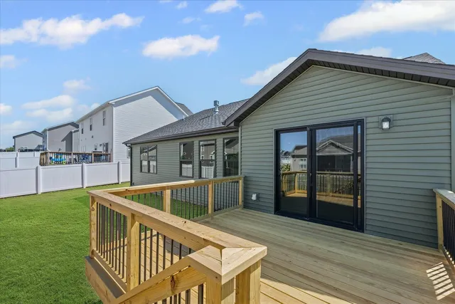a view of house with backyard and deck