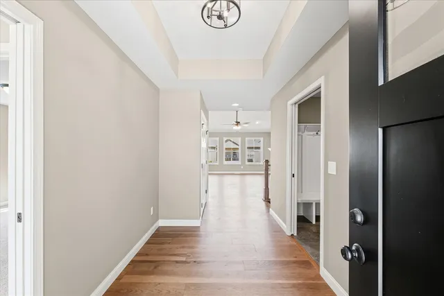 a view of a hallway with wooden floor