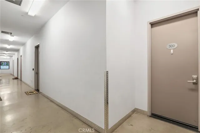 a view of a hallway with closet and wooden floor