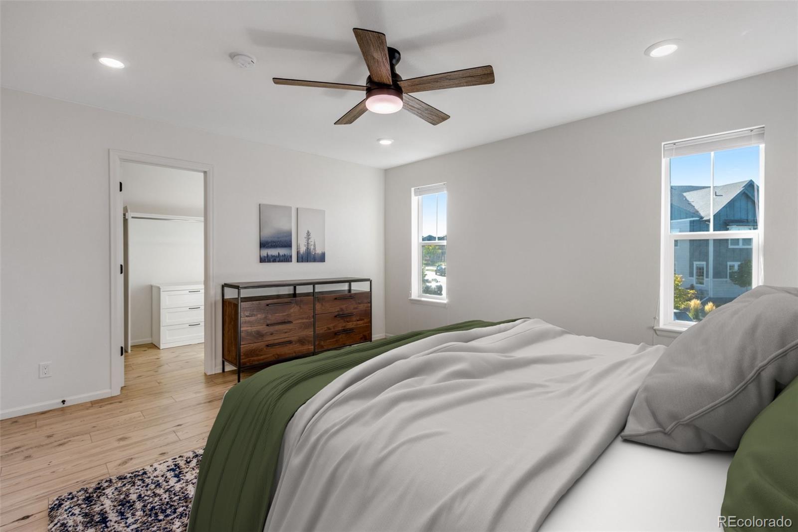 306 Rodden Drive Erie, CO 80516 - Photo 17 of 49 a bedroom with a bed and a flat screen tv