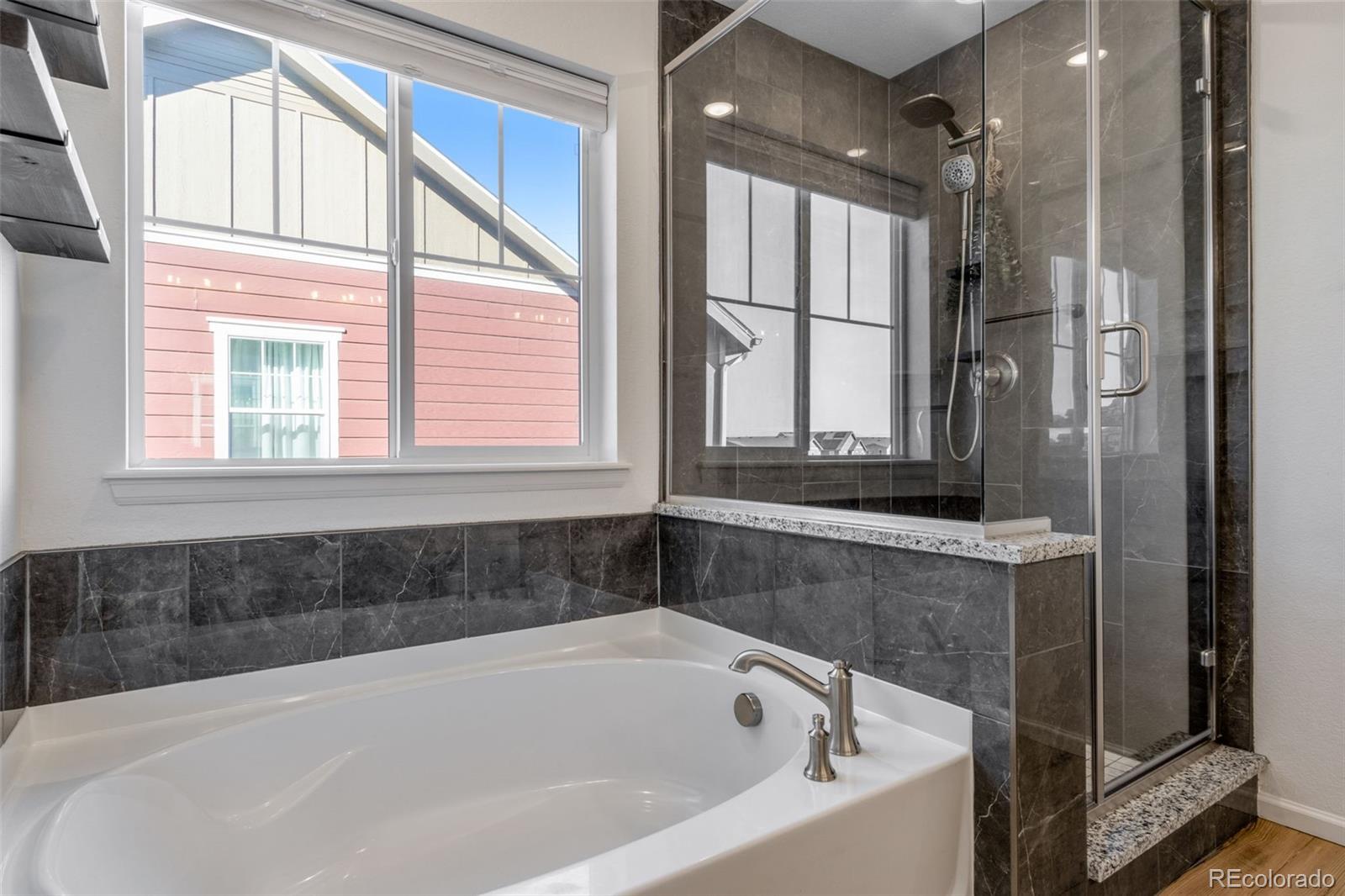 306 Rodden Drive Erie, CO 80516 - Photo 18 of 49 a bathroom with a bathtub and a shower