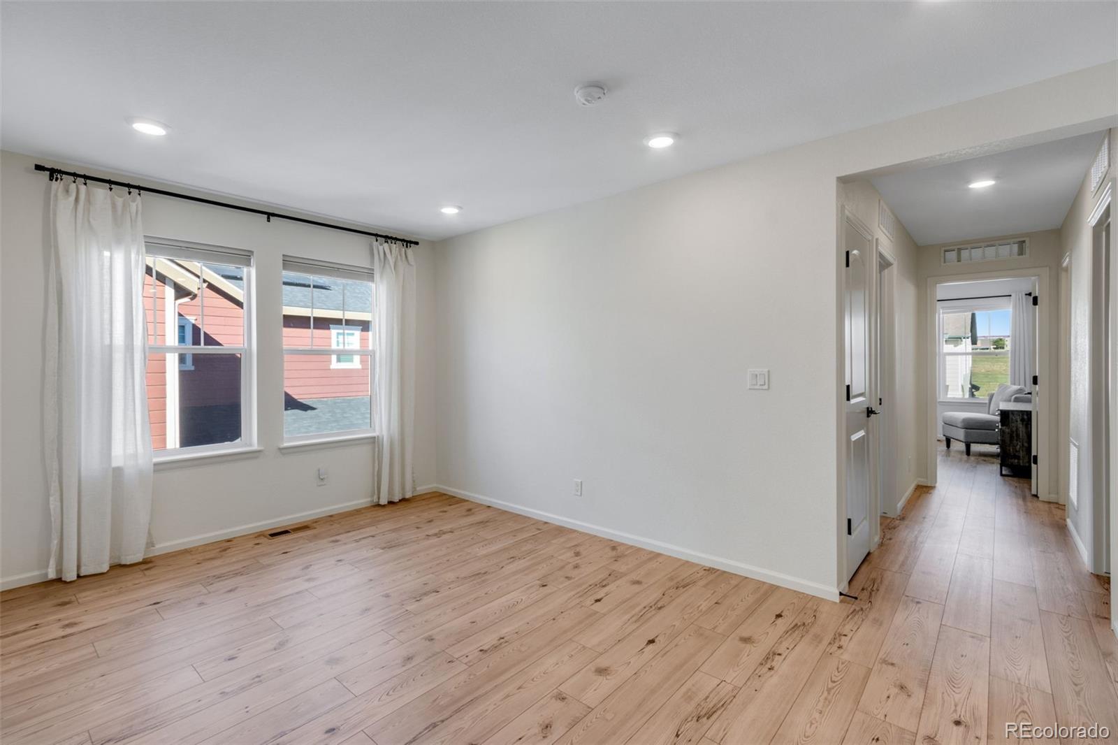 306 Rodden Drive Erie, CO 80516 - Photo 23 of 49 wooden floor in an empty room with a window