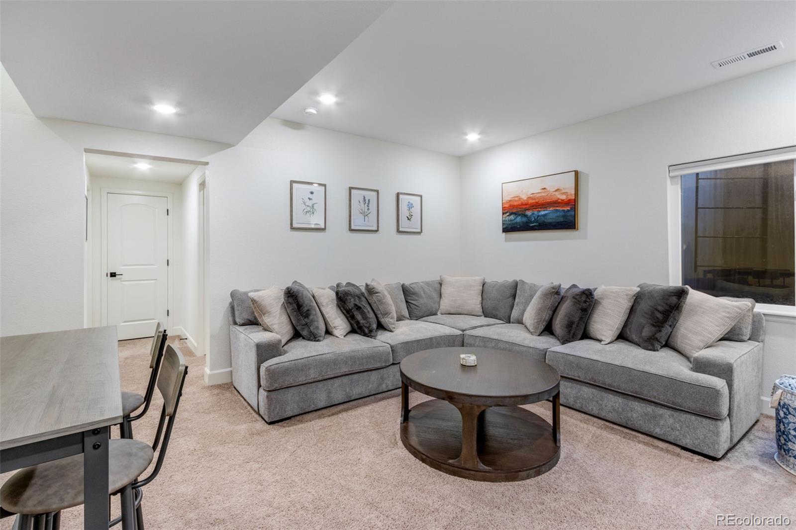 306 Rodden Drive Erie, CO 80516 - Photo 26 of 49 a living room with furniture and a flat screen tv