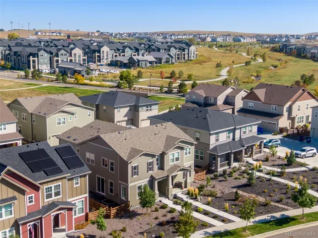 an aerial view of residential houses with outdoor space