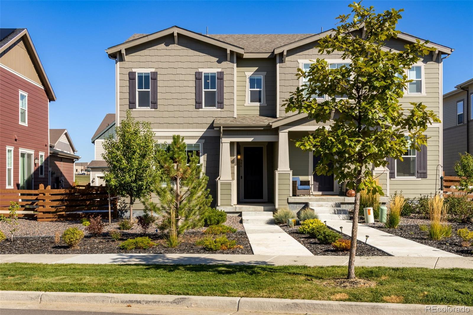 306 Rodden Drive Erie, CO 80516 - Photo 42 of 49 a front view of a house with garden